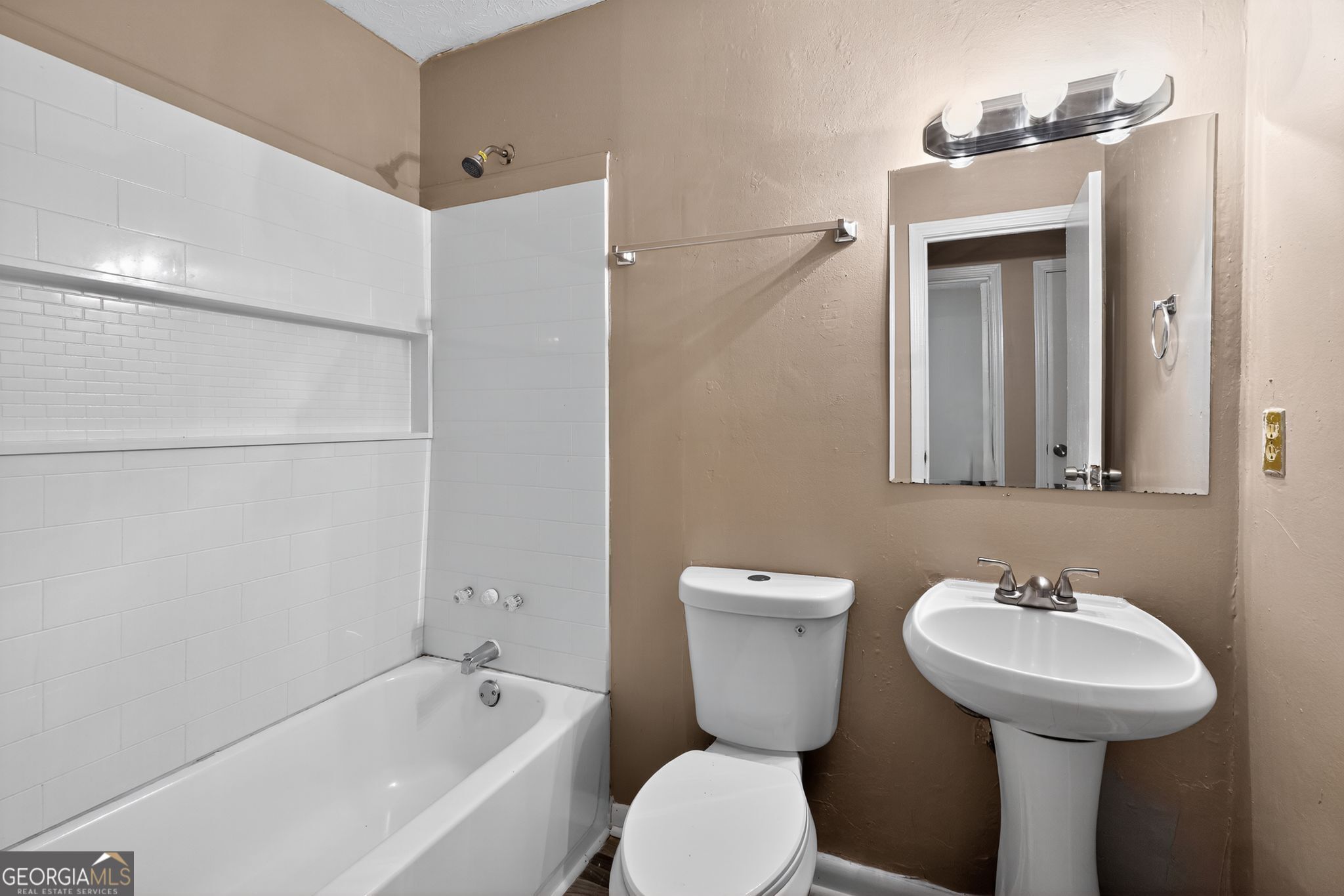 8207 Dunellen Lane Jonesboro, GA 30238 - Photo 27 of 33 a bathroom with a sink toilet and shower