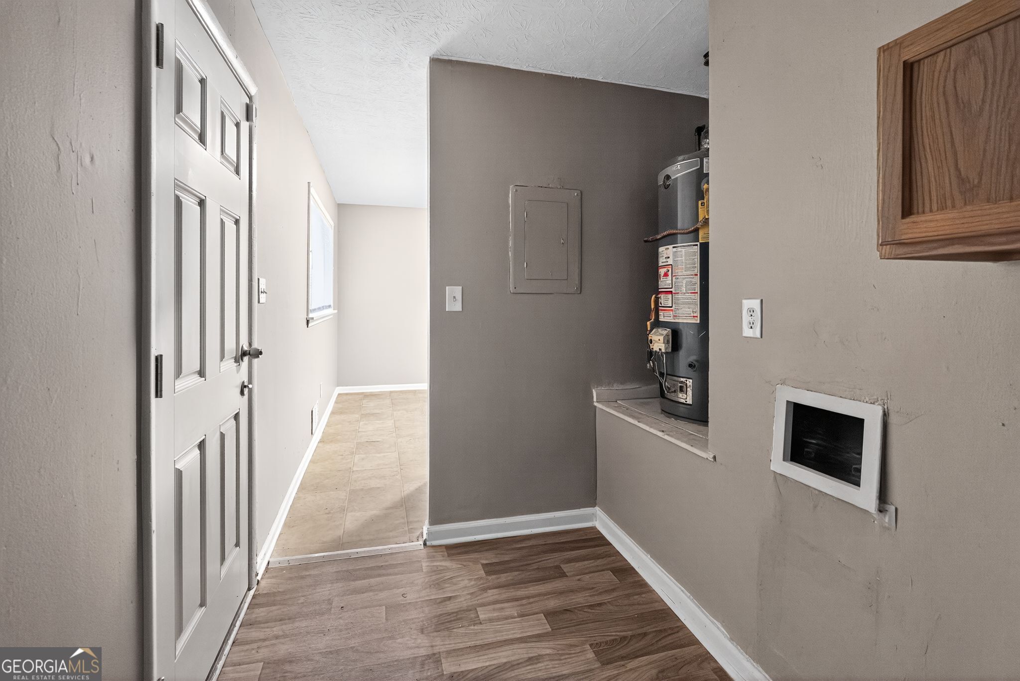 8207 Dunellen Lane Jonesboro, GA 30238 - Photo 29 of 33 a view of a hallway with wooden floor and staircase