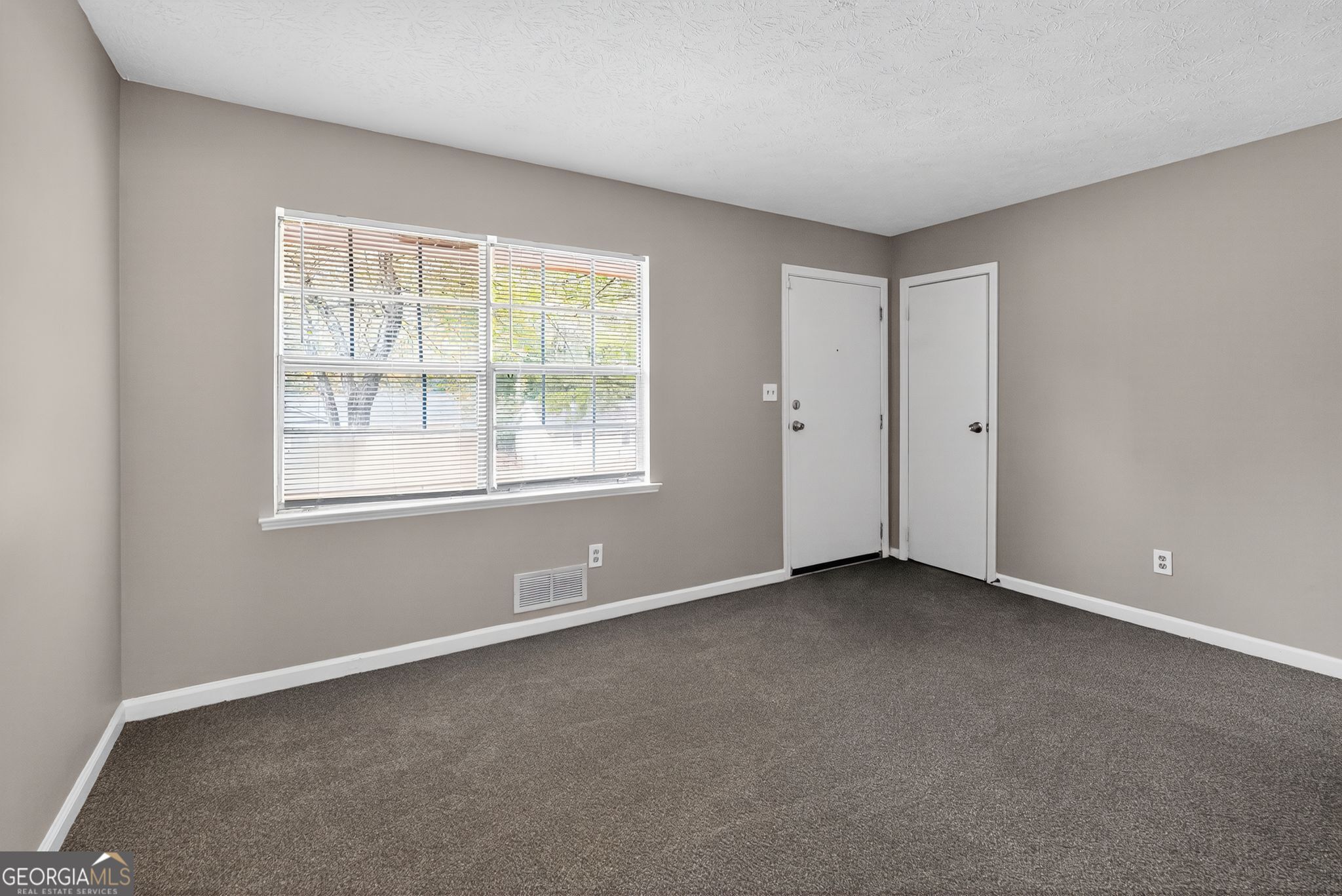 8207 Dunellen Lane Jonesboro, GA 30238 - Photo 5 of 33 an empty room with a window