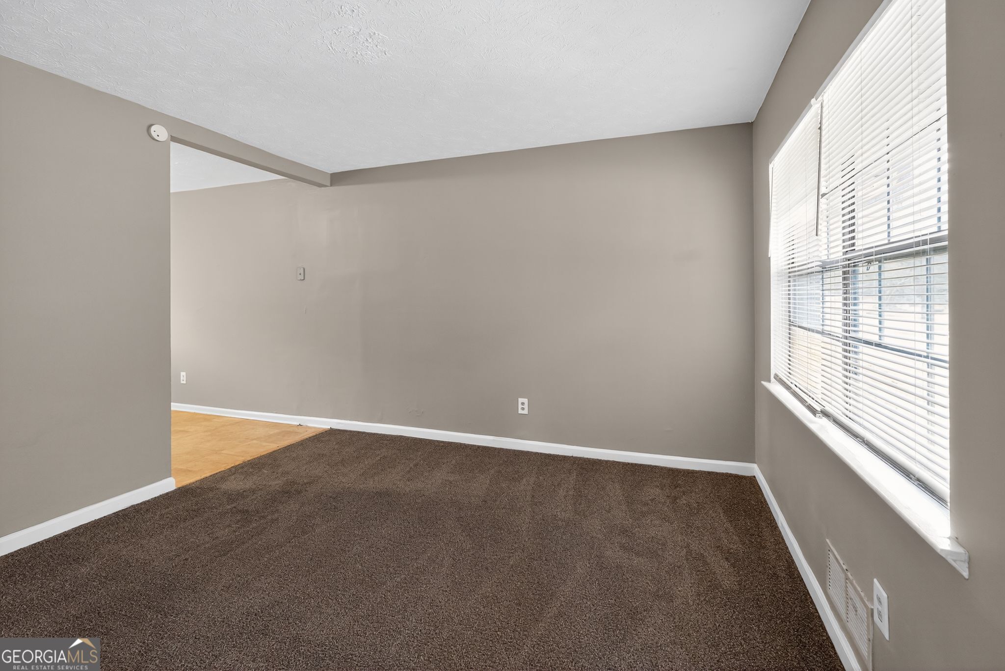 8207 Dunellen Lane Jonesboro, GA 30238 - Photo 6 of 33 a view of an empty room with a window