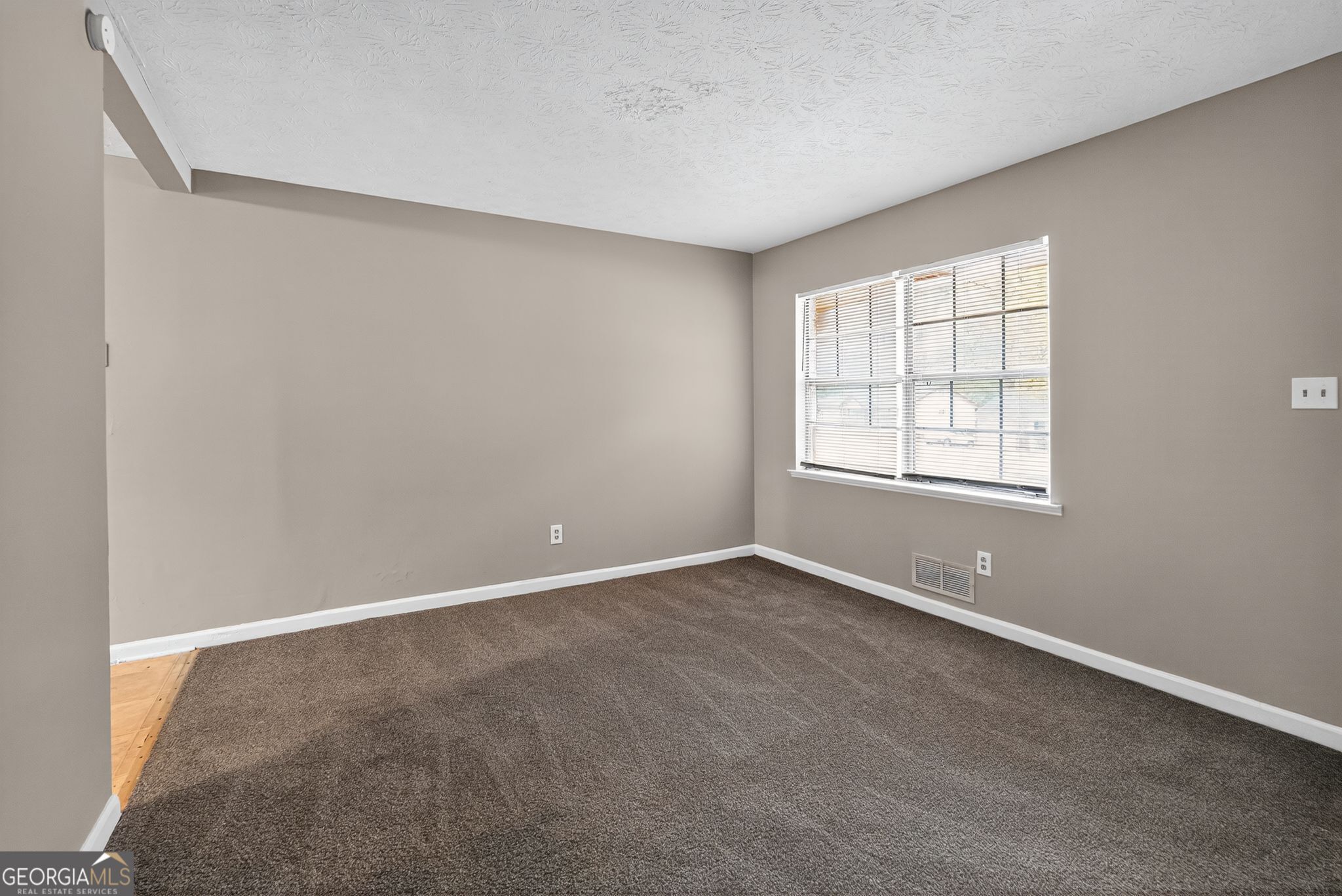 8207 Dunellen Lane Jonesboro, GA 30238 - Photo 7 of 33 an empty room with windows