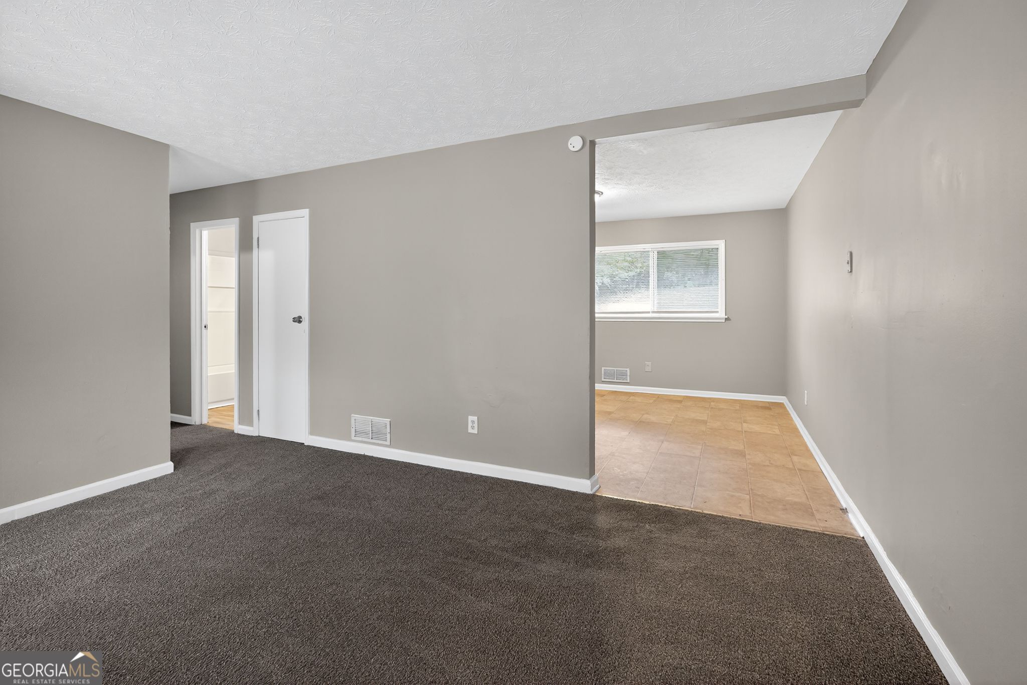 8207 Dunellen Lane Jonesboro, GA 30238 - Photo 9 of 33 a view of an empty room with a window