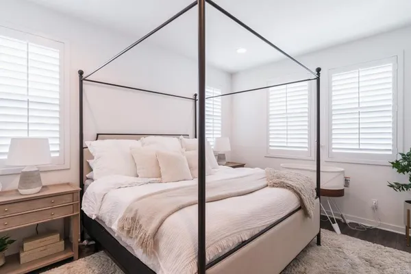 a bedroom with a large bed and a window