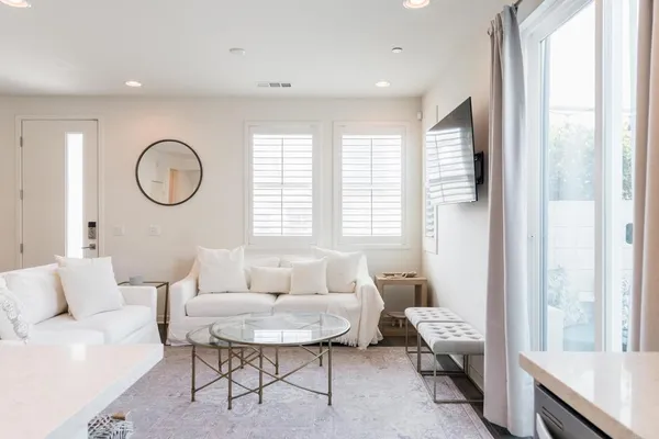 a living room with furniture and a large window