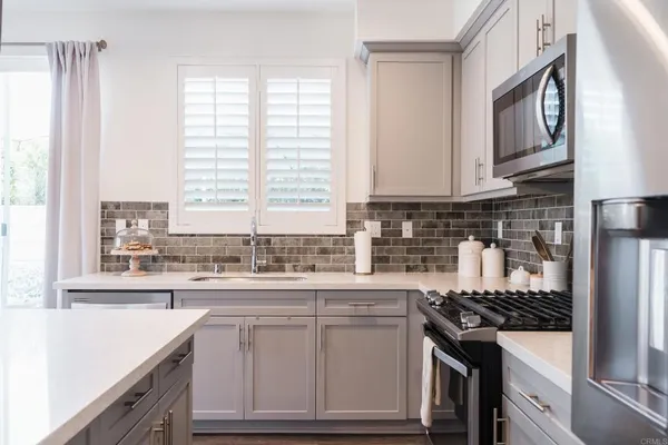 a kitchen with stainless steel appliances granite countertop a stove and a sink