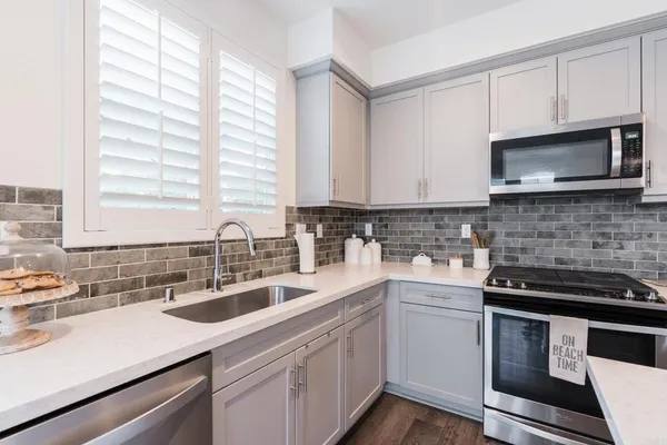 a kitchen with a sink stove and microwave