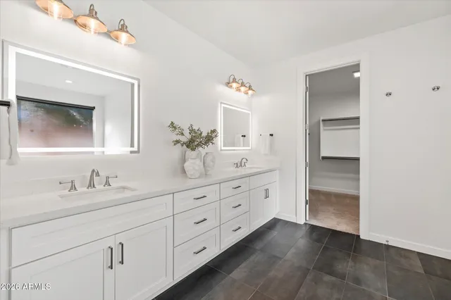 a bathroom with a double vanity sink and a mirror