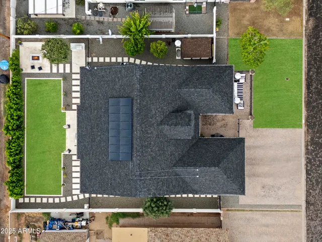 an aerial view of a house with a yard