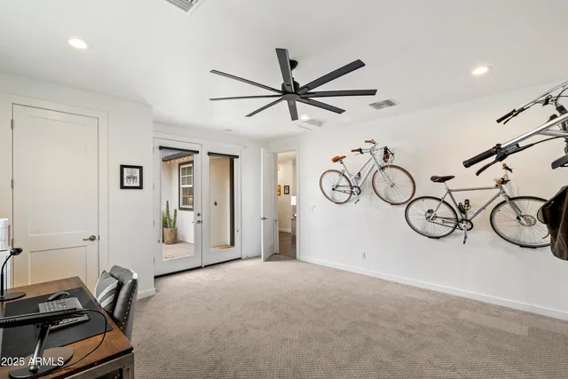 a view of a livingroom with furniture and a fan