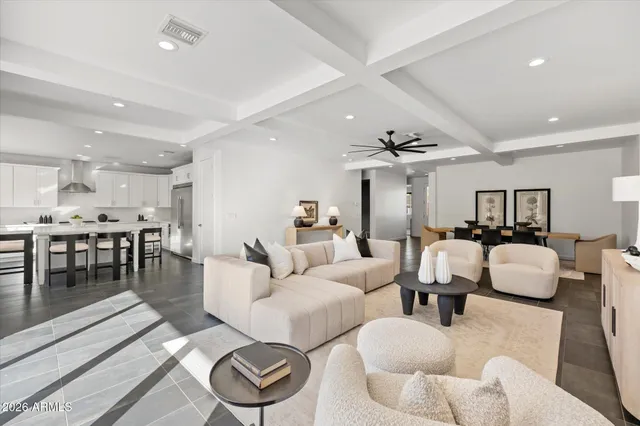 a living room with furniture and kitchen view