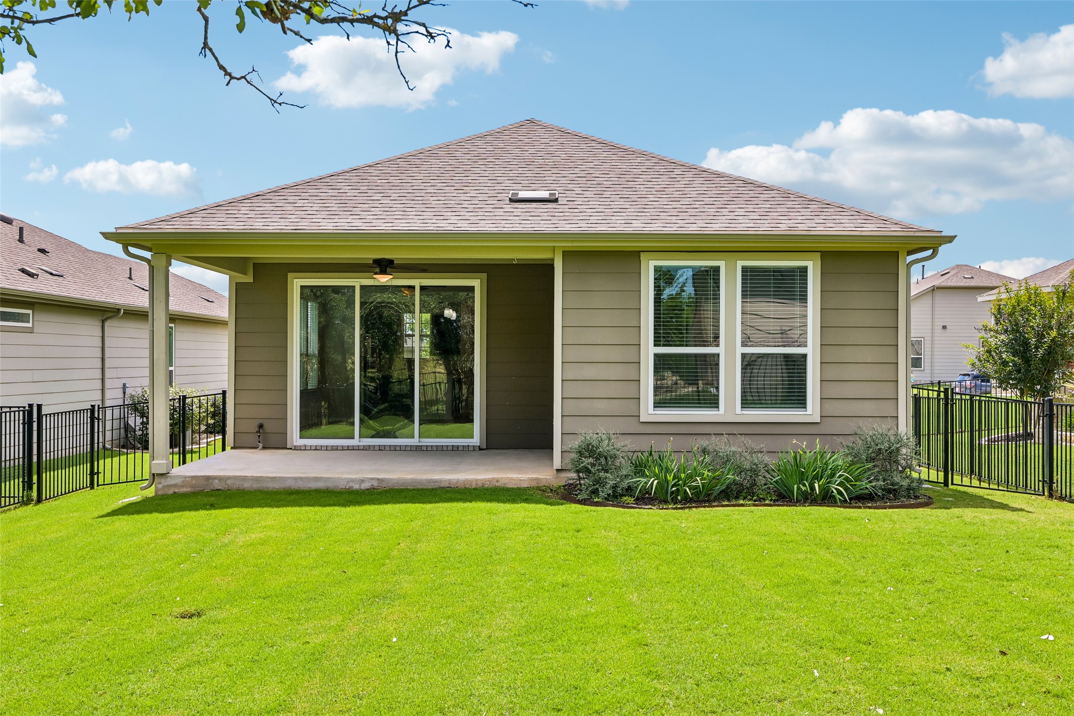 401 Yorktown Street Georgetown, TX 78633 - Photo 34 of 38 Rear exterior featuring a covered concrete patio, sliding glass door, and a horizontal siding facade