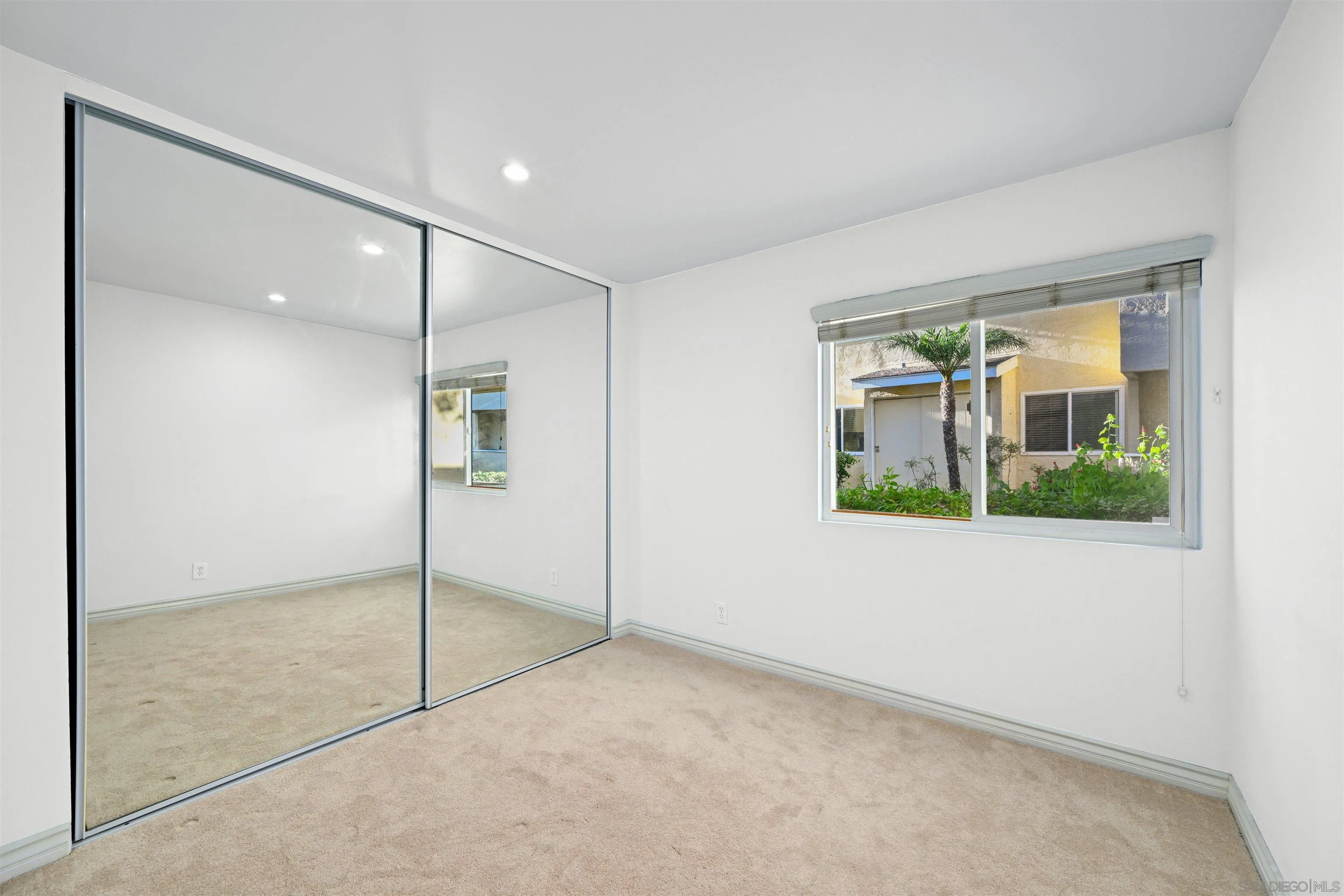 9939 Erma Road, Unit 101 San Diego, CA 92131 - Photo 14 of 24 a view of an empty room and window