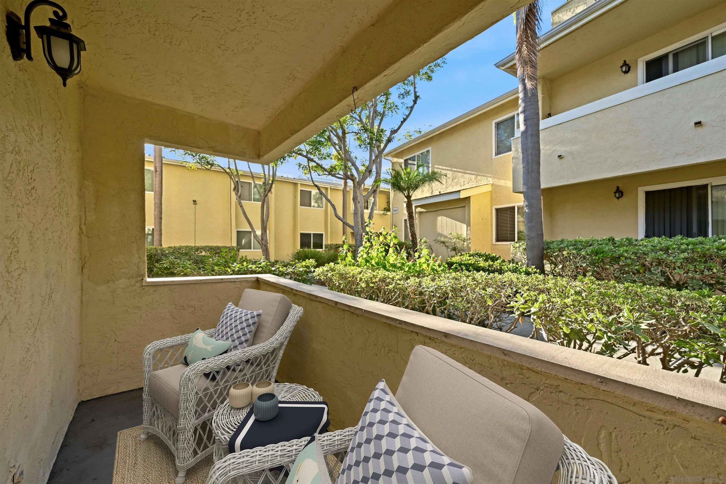 9939 Erma Road, Unit 101 San Diego, CA 92131 - Photo 17 of 24 a balcony with table and chairs