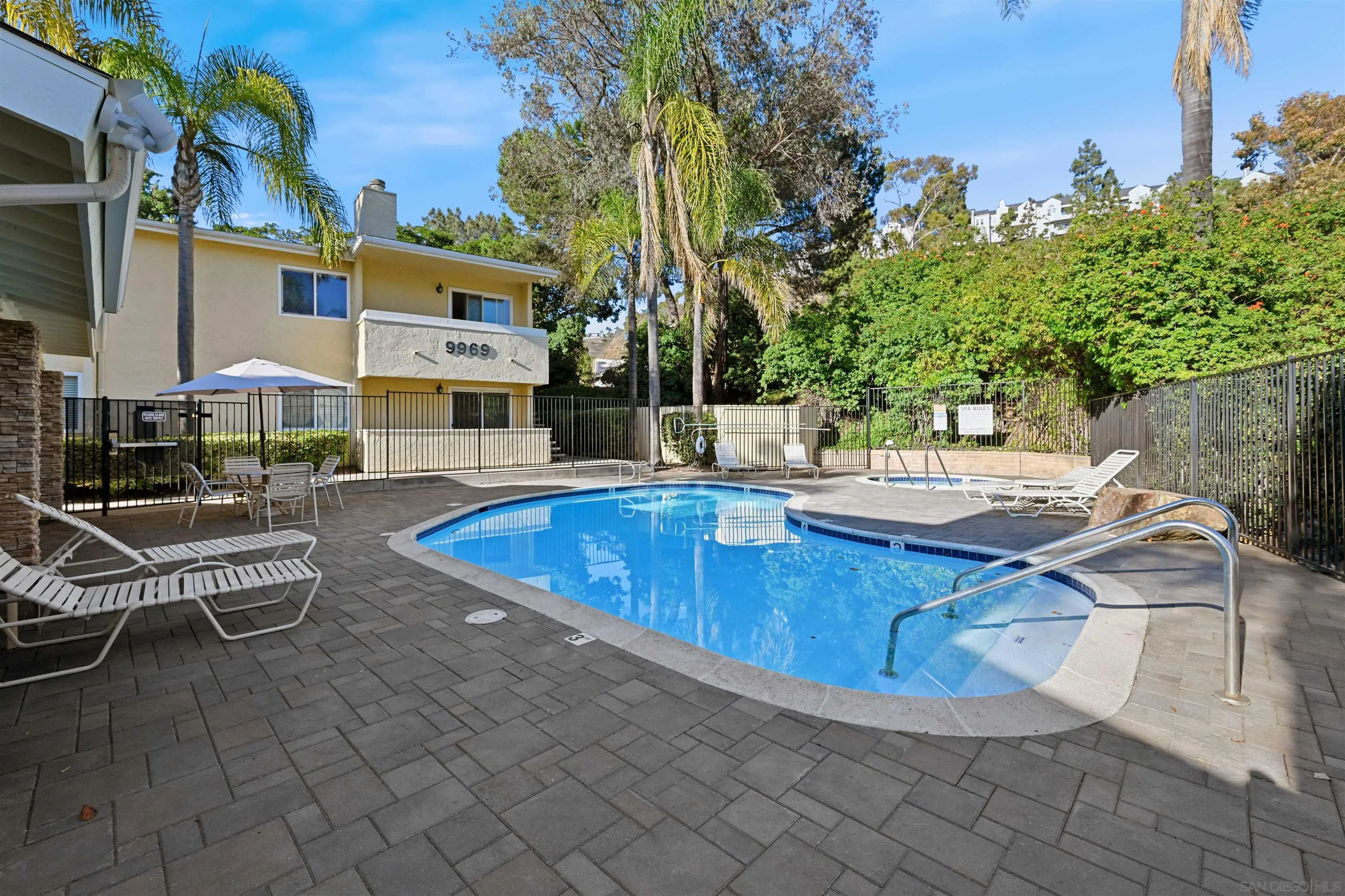 9939 Erma Road, Unit 101 San Diego, CA 92131 - Photo 22 of 24 a view of a swimming pool with lounge chairs