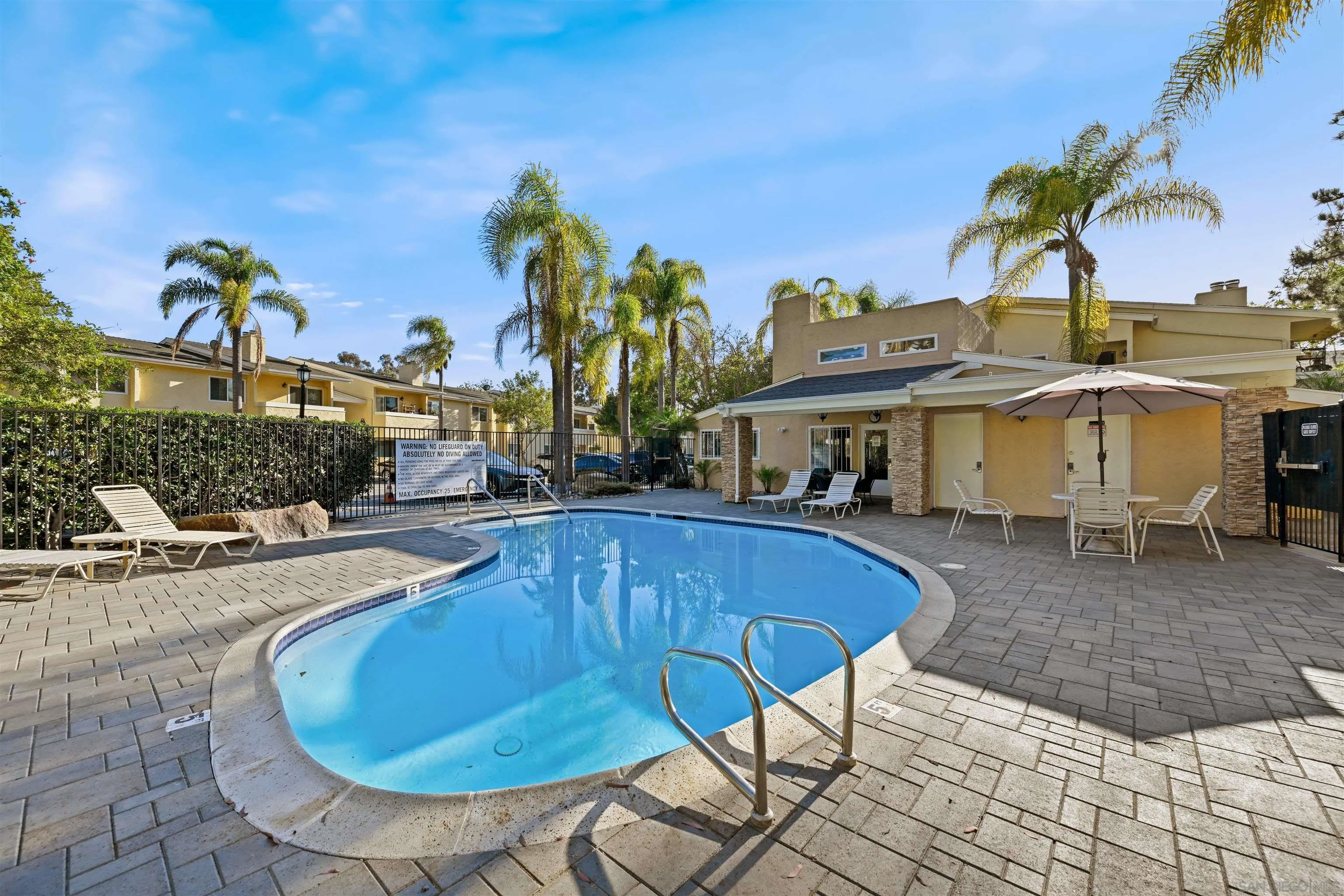 9939 Erma Road, Unit 101 San Diego, CA 92131 - Photo 23 of 24 a view of a house with swimming pool and sitting area