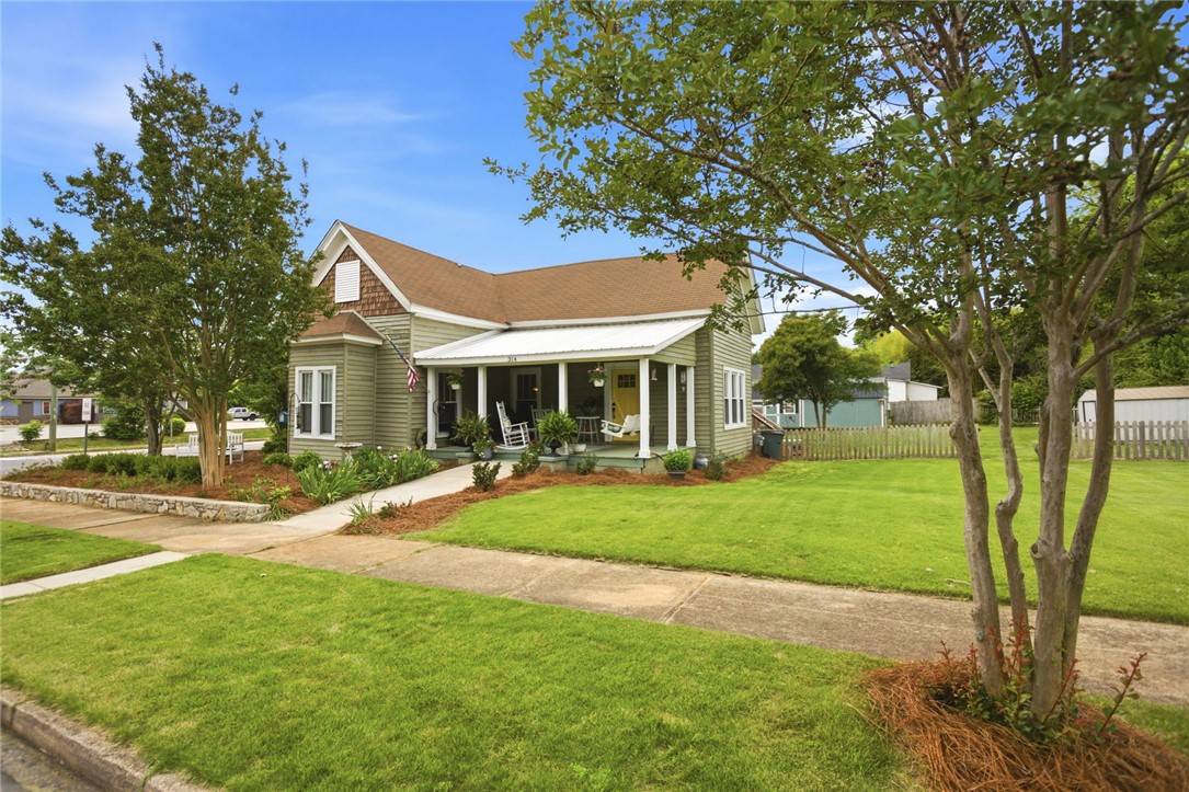 This charming home features a welcoming covered porch, perfect for outdoor relaxation.