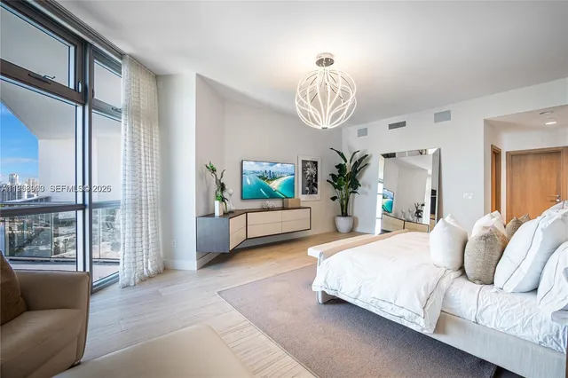 a bedroom with bed and windows