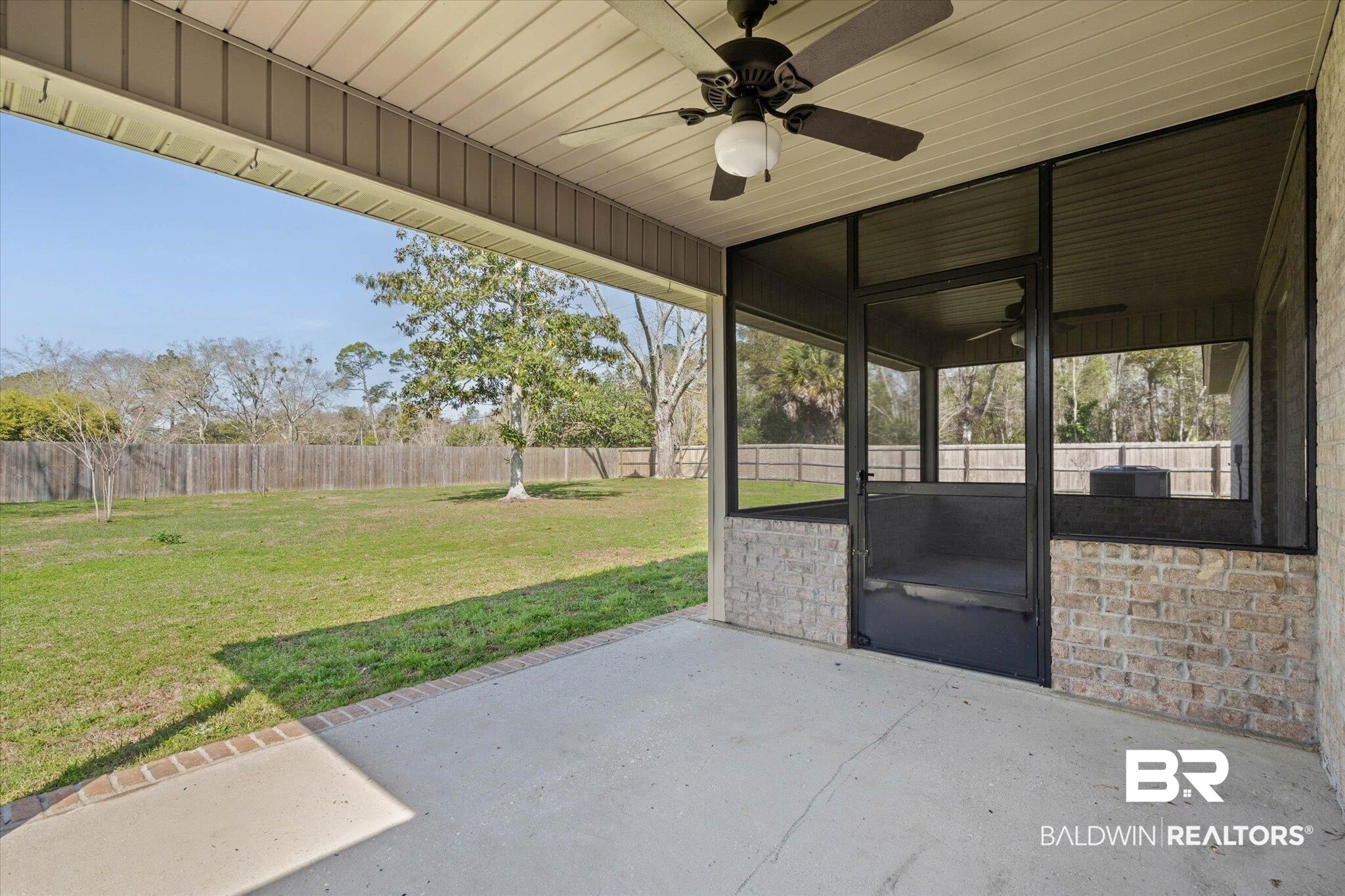 101 Washington Boulevard Foley, AL 36535 - Photo 26 of 32 Fenced backyard featuring ceiling fan and a sunroom