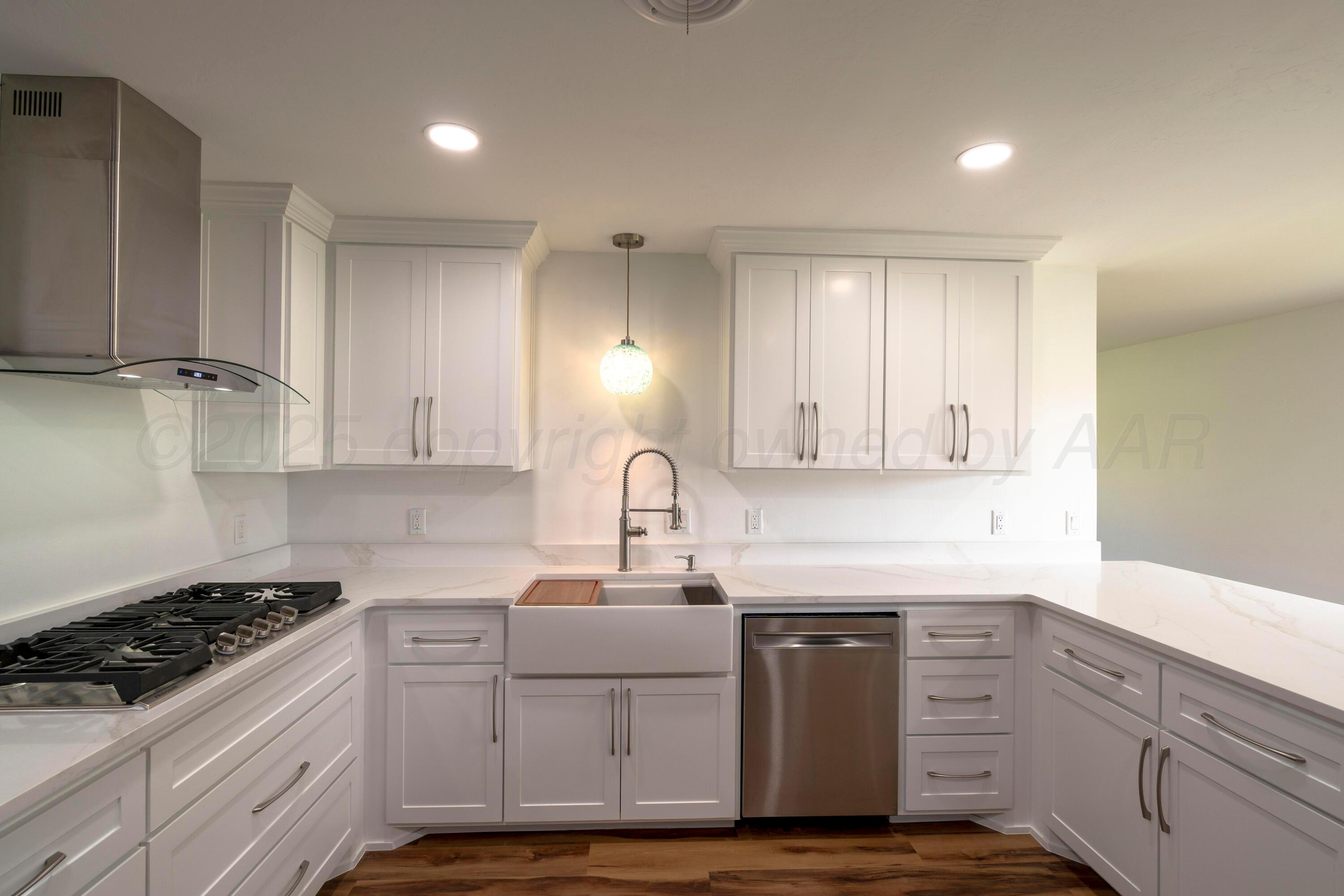 314 Overland Trail Fritch, TX 79036 - Photo 12 of 36 a kitchen with sink cabinets and stove top oven
