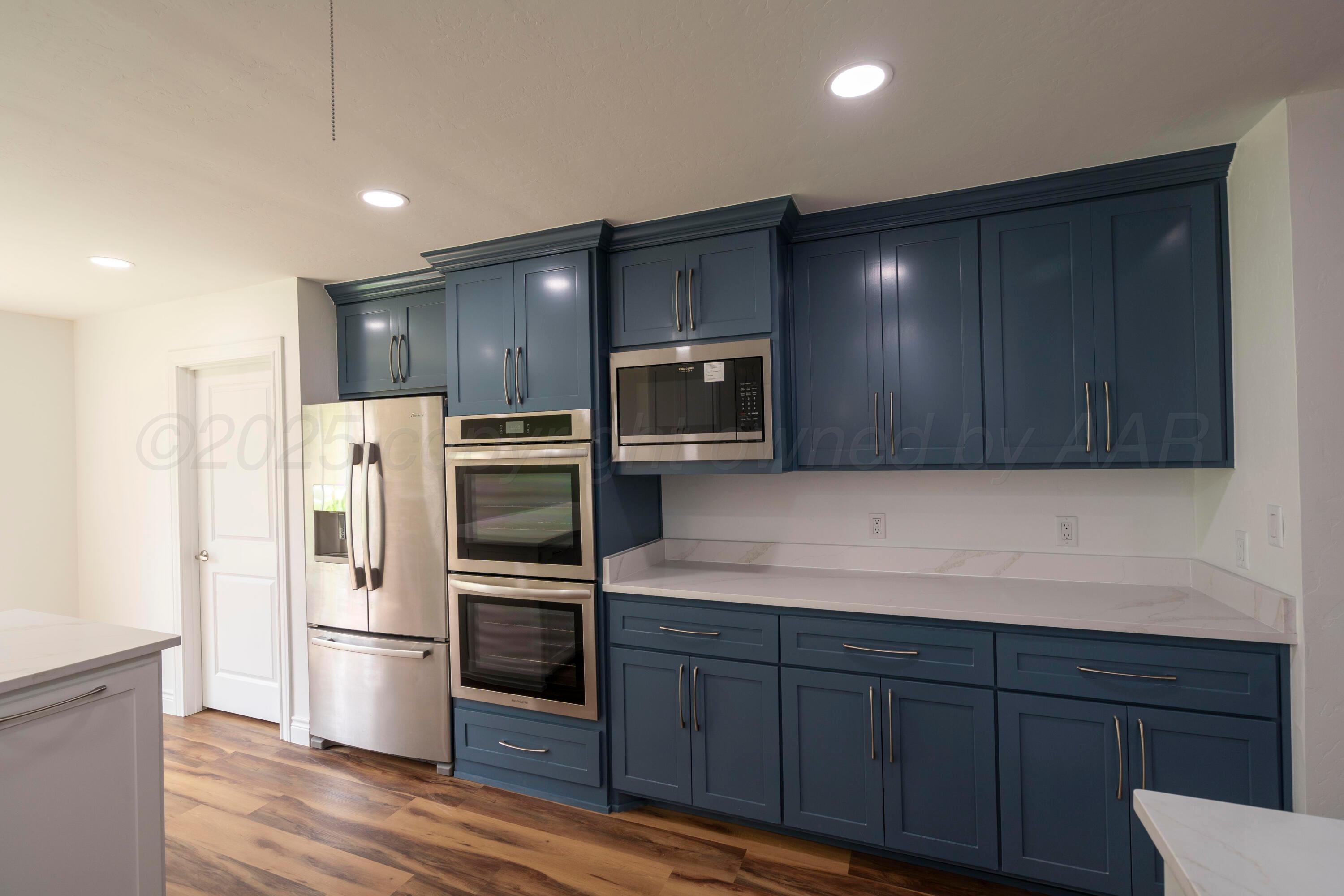 314 Overland Trail Fritch, TX 79036 - Photo 14 of 36 a kitchen with stainless steel appliances a refrigerator and wooden cabinets