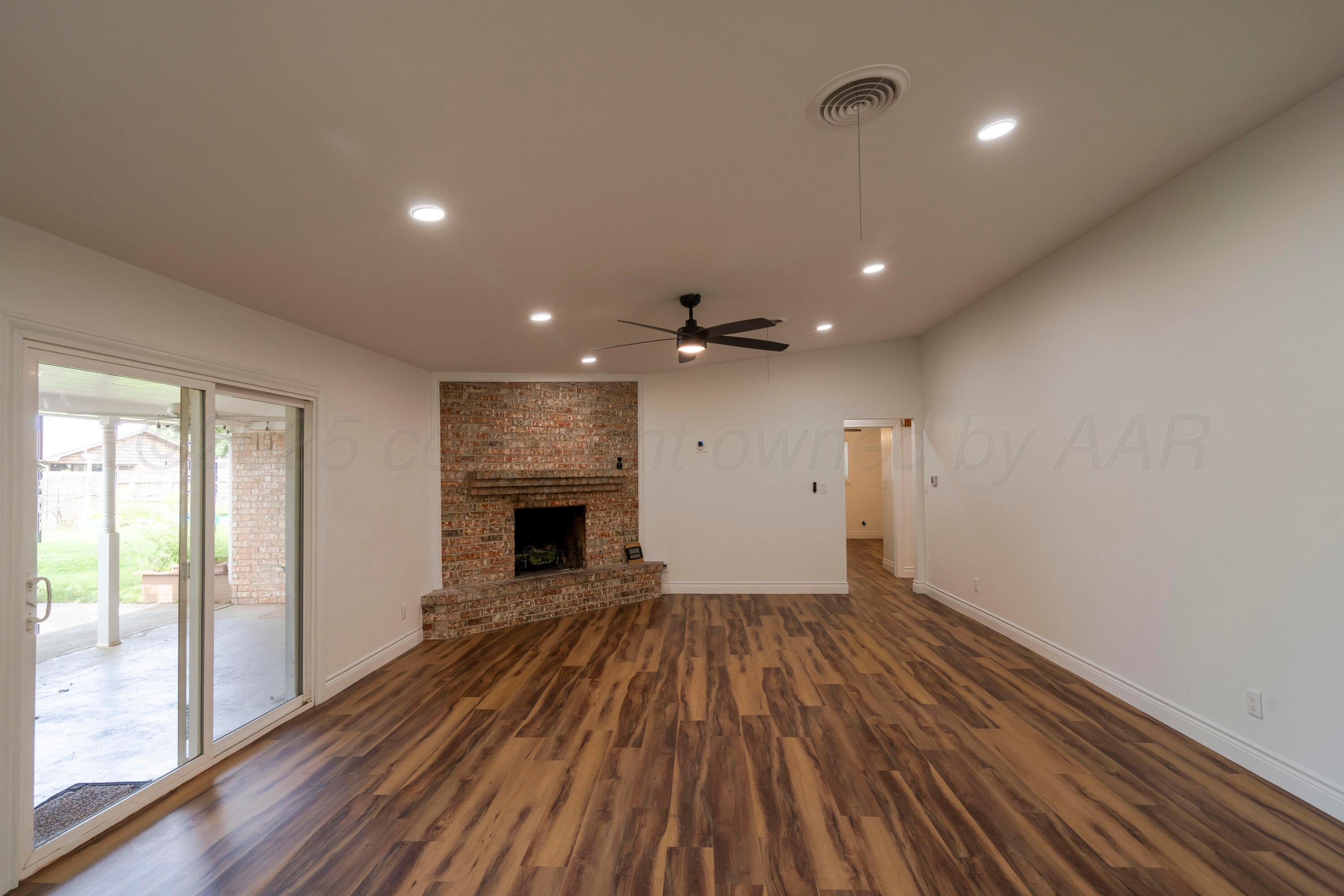 314 Overland Trail Fritch, TX 79036 - Photo 19 of 36 a view of empty room with wooden floor and fireplace