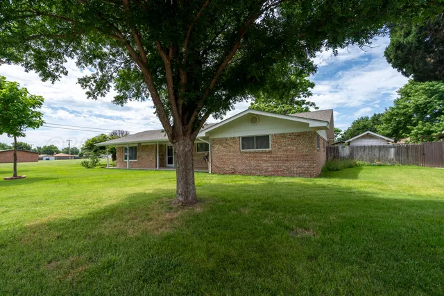 a view of an house with backyard space and garden