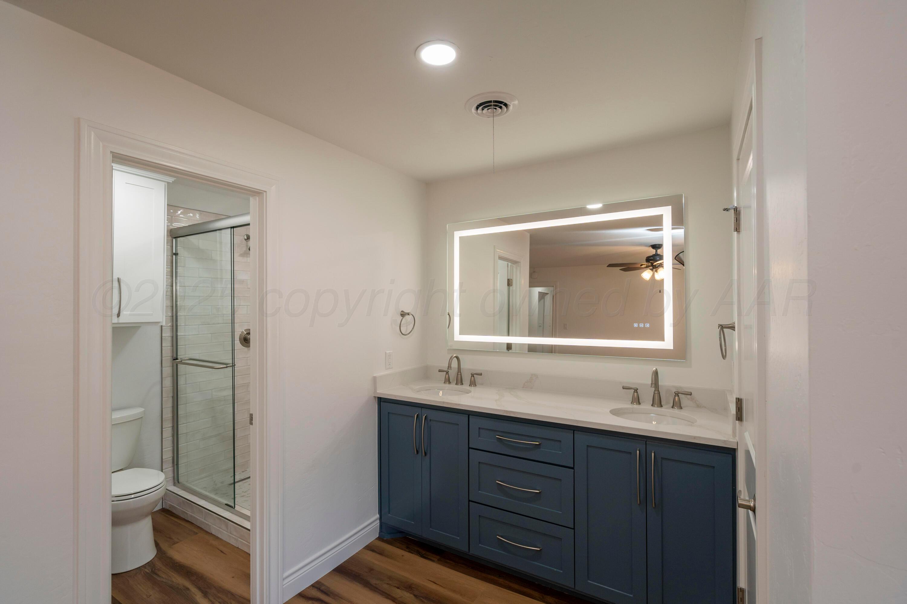 314 Overland Trail Fritch, TX 79036 - Photo 22 of 36 a bathroom with a granite countertop sink toilet and shower