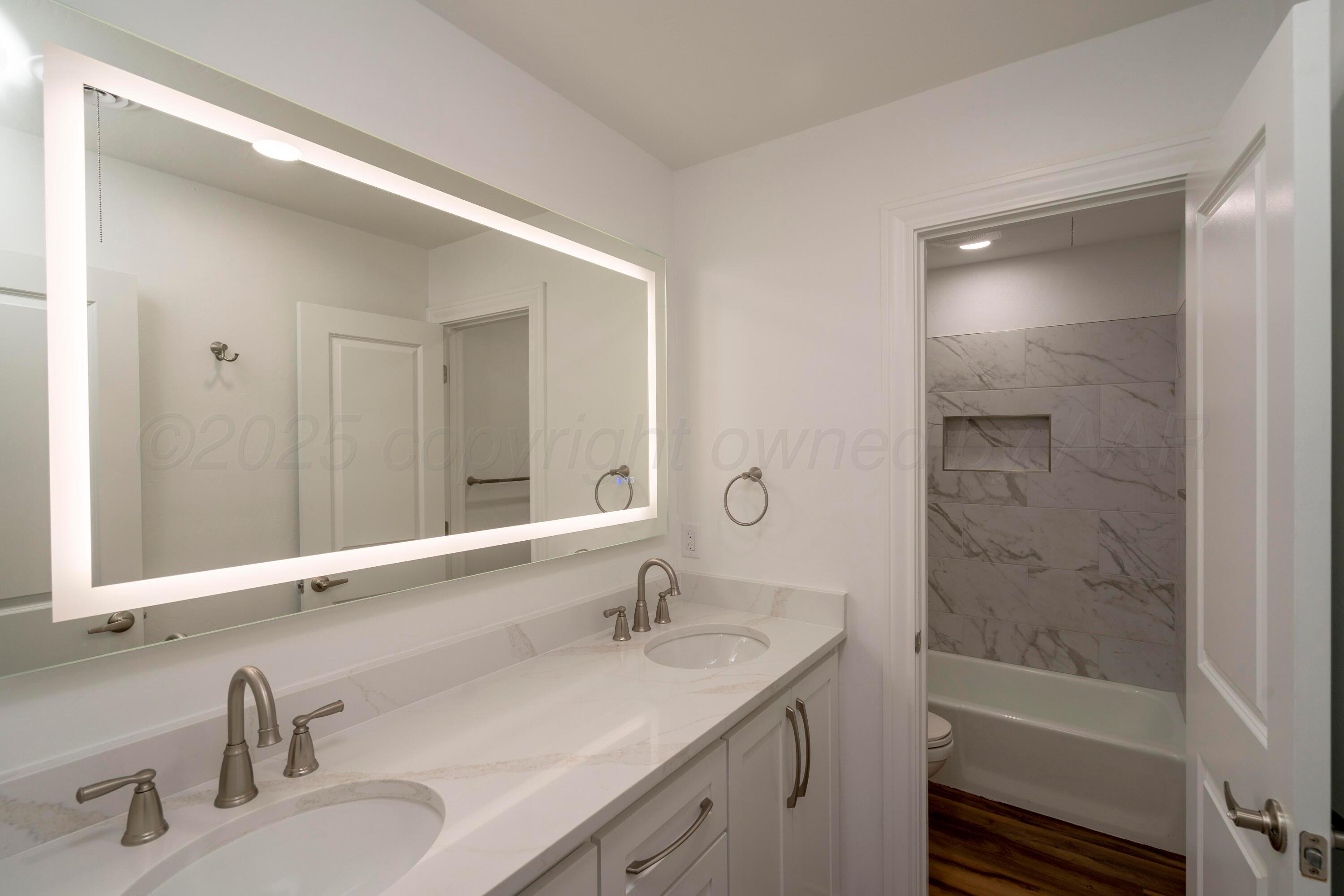 314 Overland Trail Fritch, TX 79036 - Photo 30 of 36 a bathroom with a sink and a large mirror