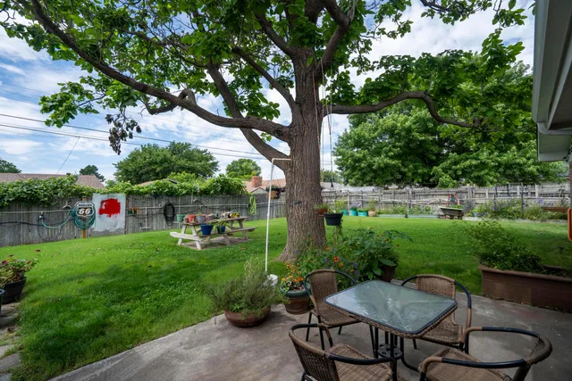 a view of a backyard with sitting area