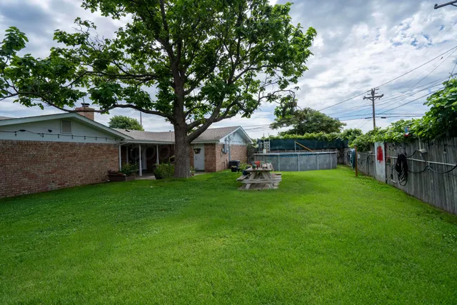 a house view with a sitting space and garden