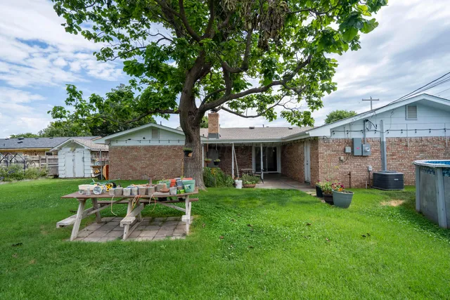 a view of a backyard with swimming pool