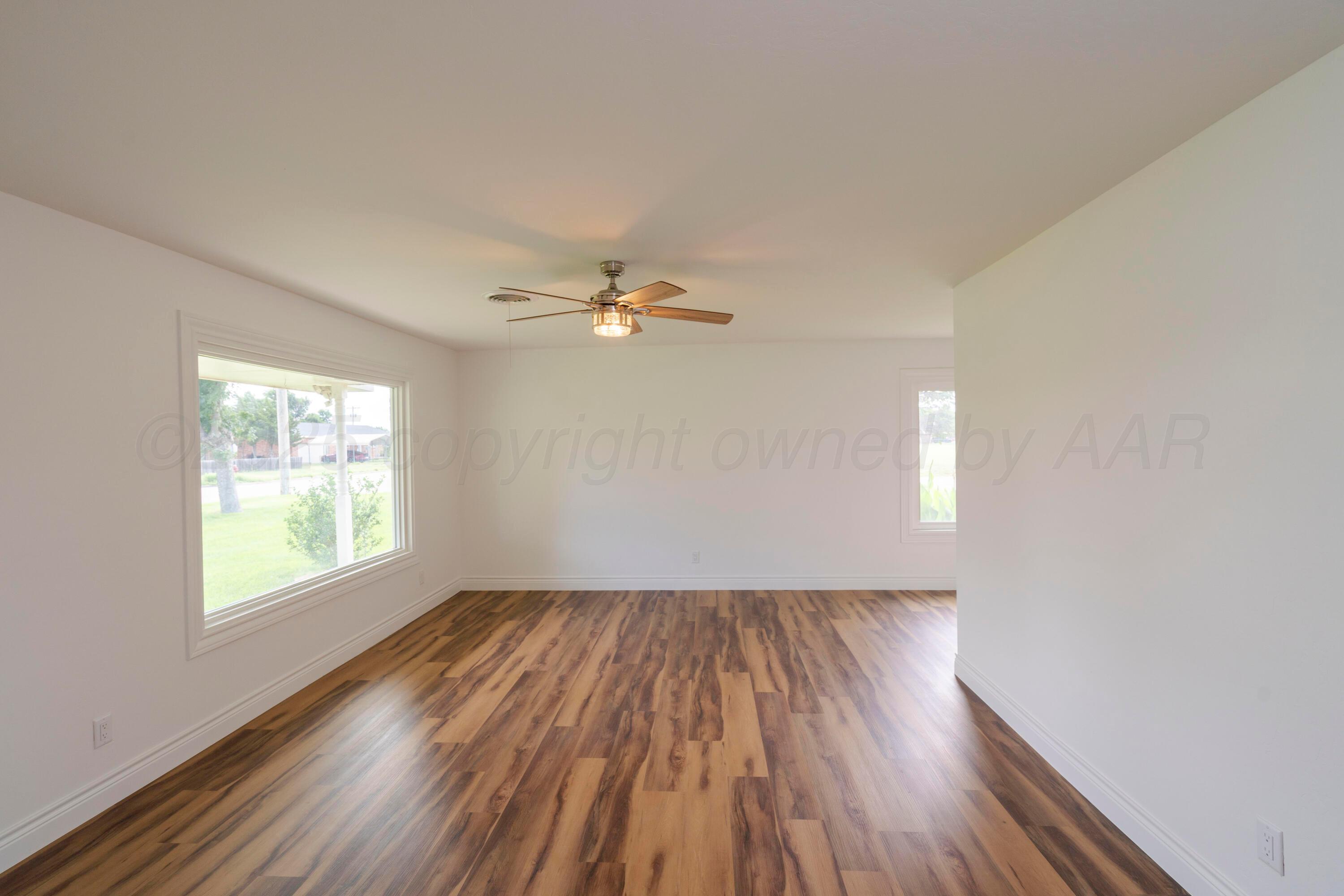 314 Overland Trail Fritch, TX 79036 - Photo 7 of 36 wooden floor in an empty room with a window