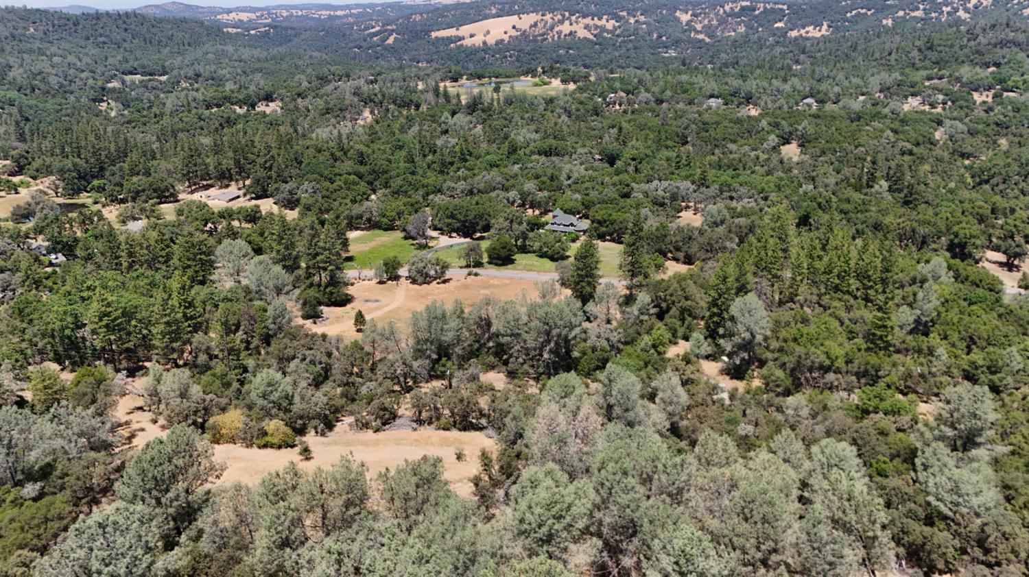21833 McCourtney Road Grass Valley, CA 95949 - Photo 12 of 40 a view of a forest with a street and trees