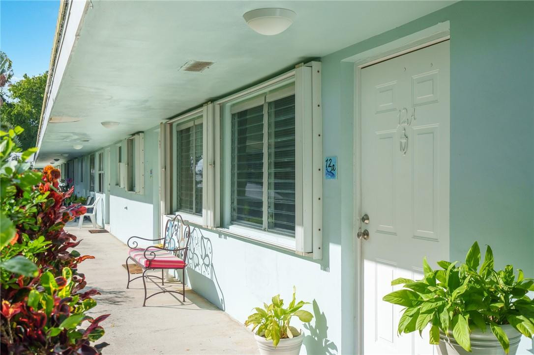3801 Northeast 22nd Terrace, Unit 12A Lighthouse Point, FL 33064 - Photo 1 of 34 a front view of a house with a garden