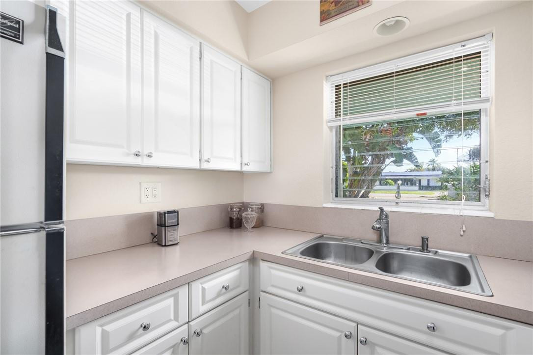 3801 Northeast 22nd Terrace, Unit 12A Lighthouse Point, FL 33064 - Photo 11 of 34 a kitchen with a sink and cabinets