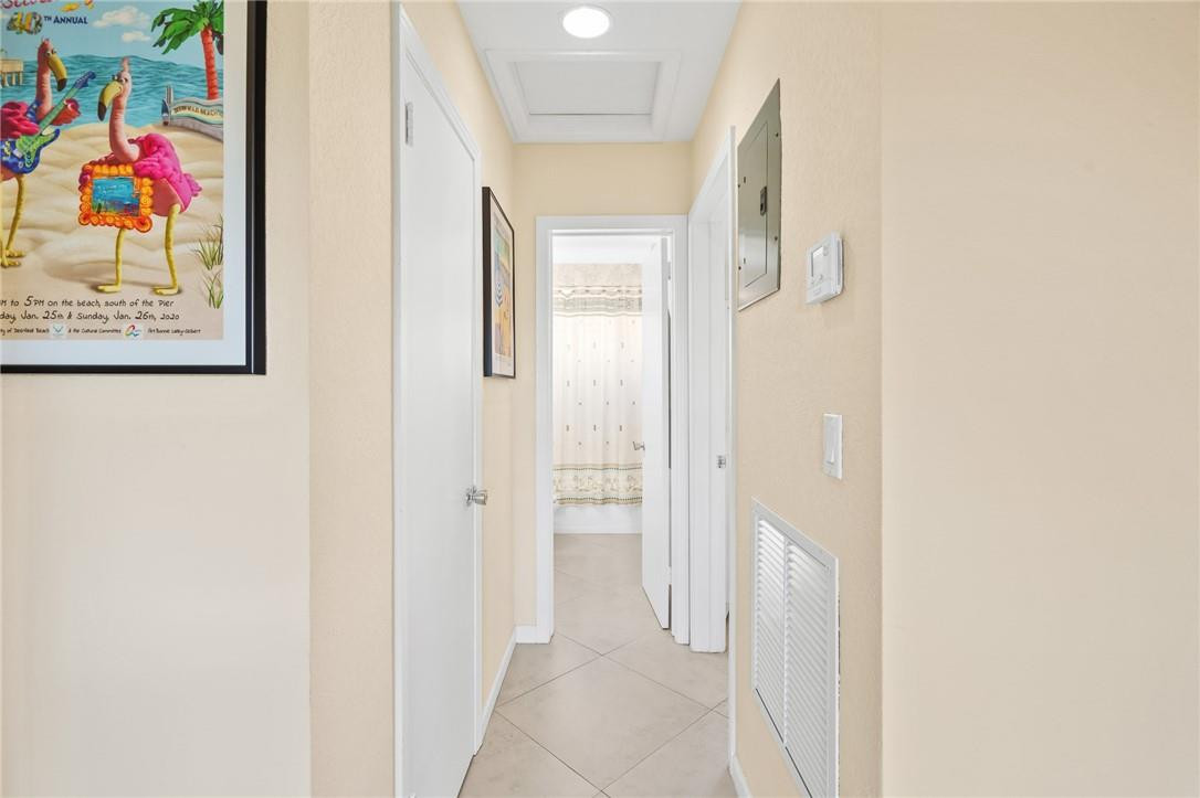3801 Northeast 22nd Terrace, Unit 12A Lighthouse Point, FL 33064 - Photo 12 of 34 a view of a hallway with paintings on the wall