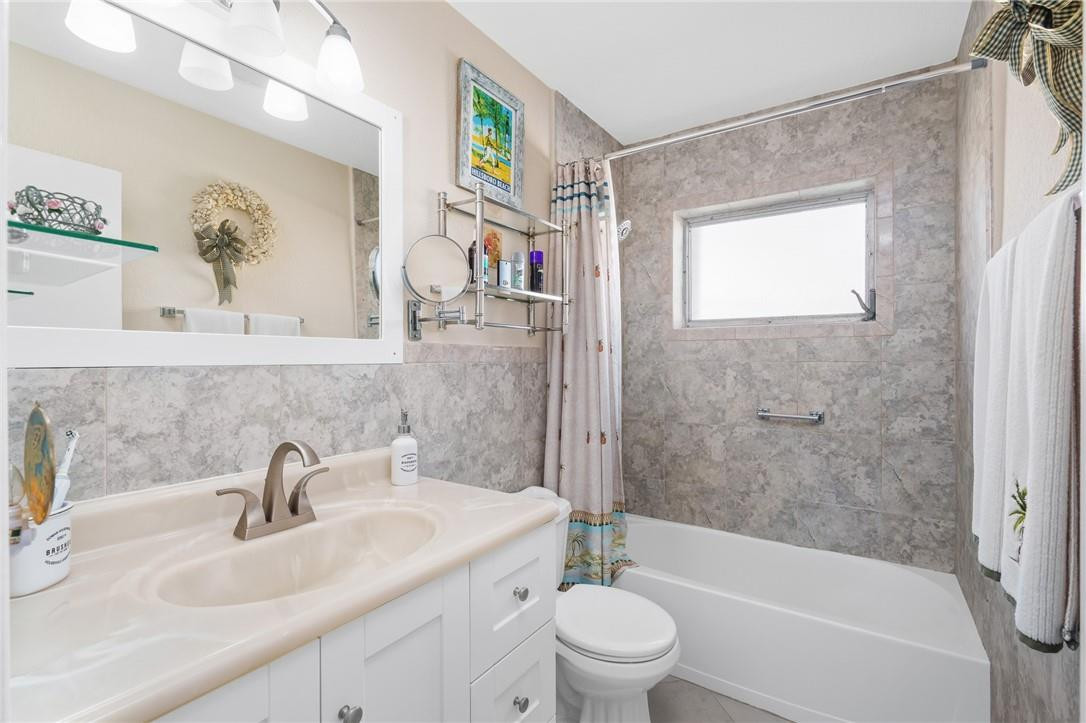3801 Northeast 22nd Terrace, Unit 12A Lighthouse Point, FL 33064 - Photo 13 of 34 a bathroom with a sink a toilet and shower