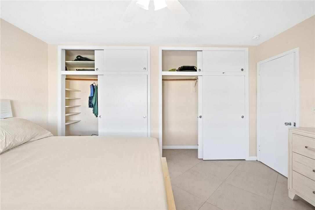 3801 Northeast 22nd Terrace, Unit 12A Lighthouse Point, FL 33064 - Photo 16 of 34 a bedroom with a bed and a cabinets