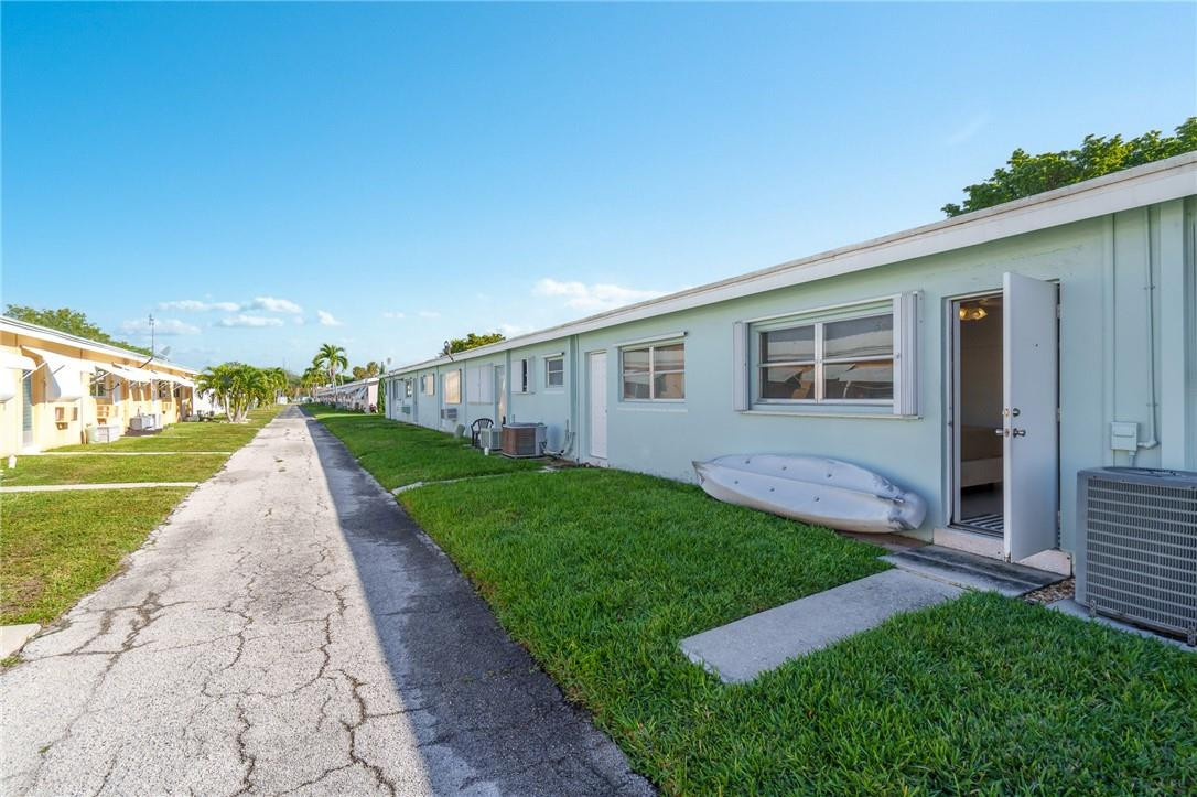 3801 Northeast 22nd Terrace, Unit 12A Lighthouse Point, FL 33064 - Photo 19 of 34 a view of a house with a yard