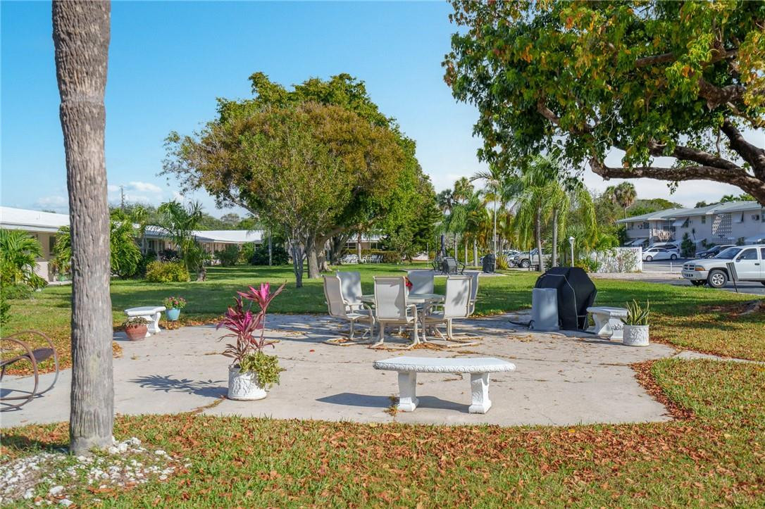 3801 Northeast 22nd Terrace, Unit 12A Lighthouse Point, FL 33064 - Photo 28 of 34 a view of a house with backyard porch and sitting area