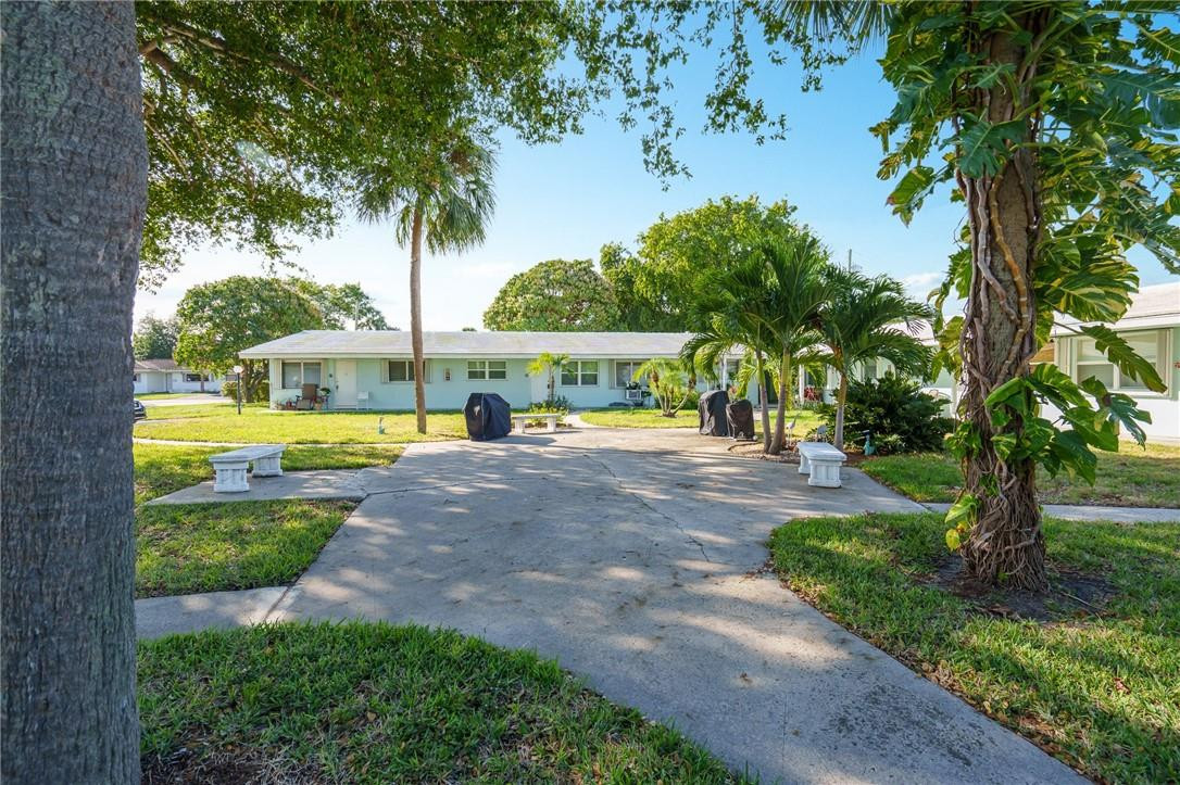 3801 Northeast 22nd Terrace, Unit 12A Lighthouse Point, FL 33064 - Photo 30 of 34 a view of a house with swimming pool and a garden