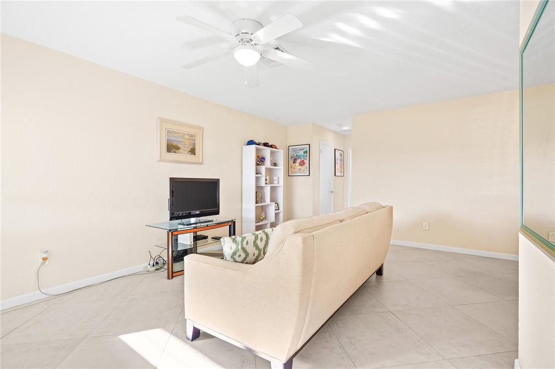 3801 Northeast 22nd Terrace, Unit 12A Lighthouse Point, FL 33064 - Photo 3 of 34 a living room with furniture and a flat screen tv