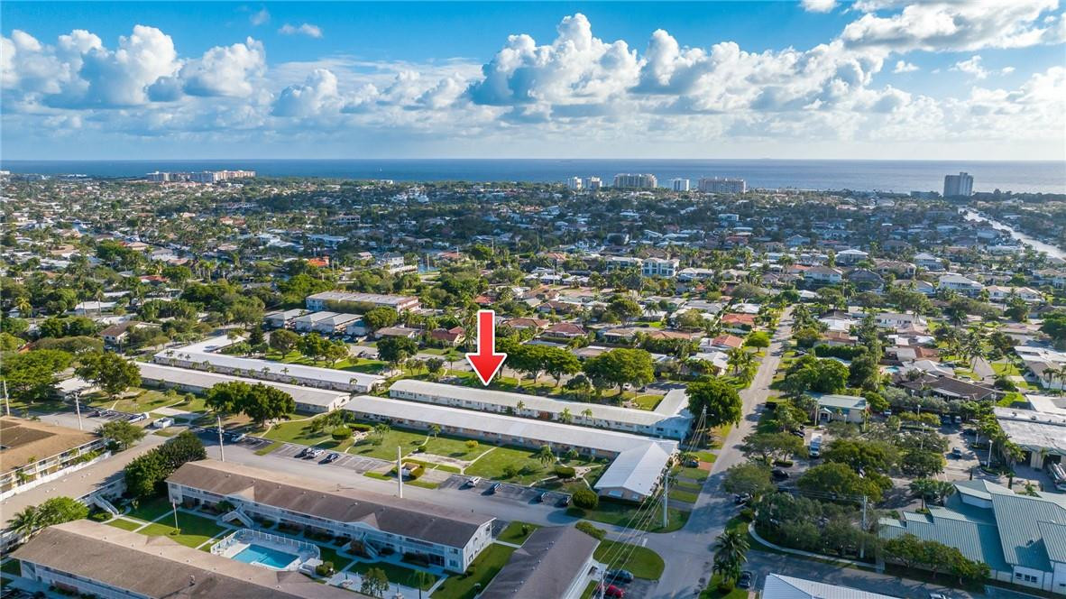 3801 Northeast 22nd Terrace, Unit 12A Lighthouse Point, FL 33064 - Photo 33 of 34 an aerial view of a city with lots of residential buildings ocean and mountain view in back