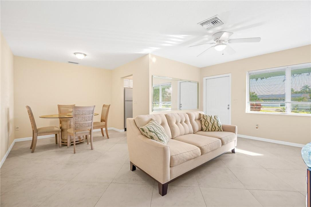 3801 Northeast 22nd Terrace, Unit 12A Lighthouse Point, FL 33064 - Photo 6 of 34 a living room with furniture and a large window