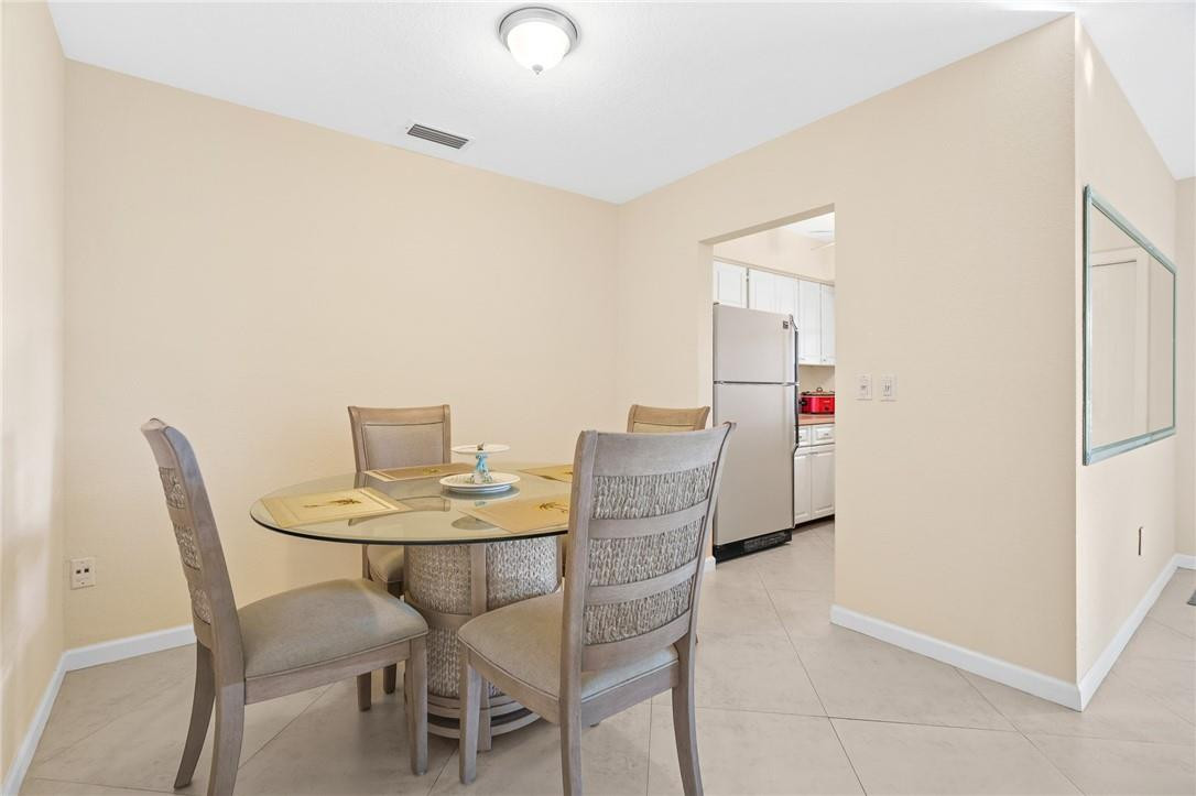 3801 Northeast 22nd Terrace, Unit 12A Lighthouse Point, FL 33064 - Photo 7 of 34 a dining room with furniture and wooden floor