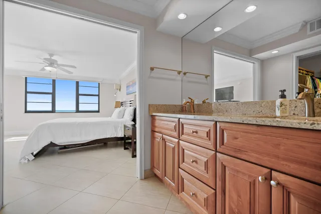 a bathroom with a granite countertop sink a mirror and a shower