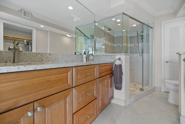 a living room with furniture and a flat screen tv with kitchen view