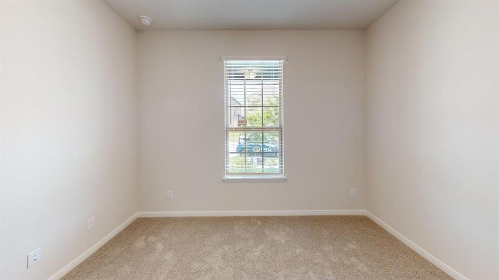1840 Rosedale Avenue Van Alstyne, TX 75495 - Photo 15 of 24 Neutral wall paint and carpeting throughout, featuring a single window with blinds