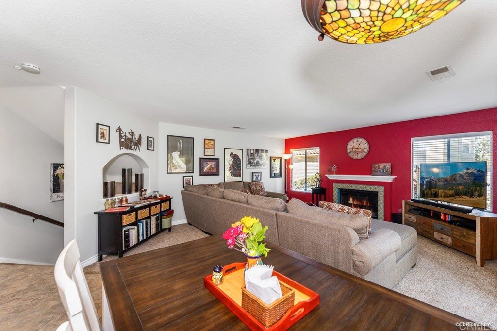 1840 Century Way Escondido, CA 92026 - Photo 11 of 36 a living room with furniture a flat screen tv and a fireplace