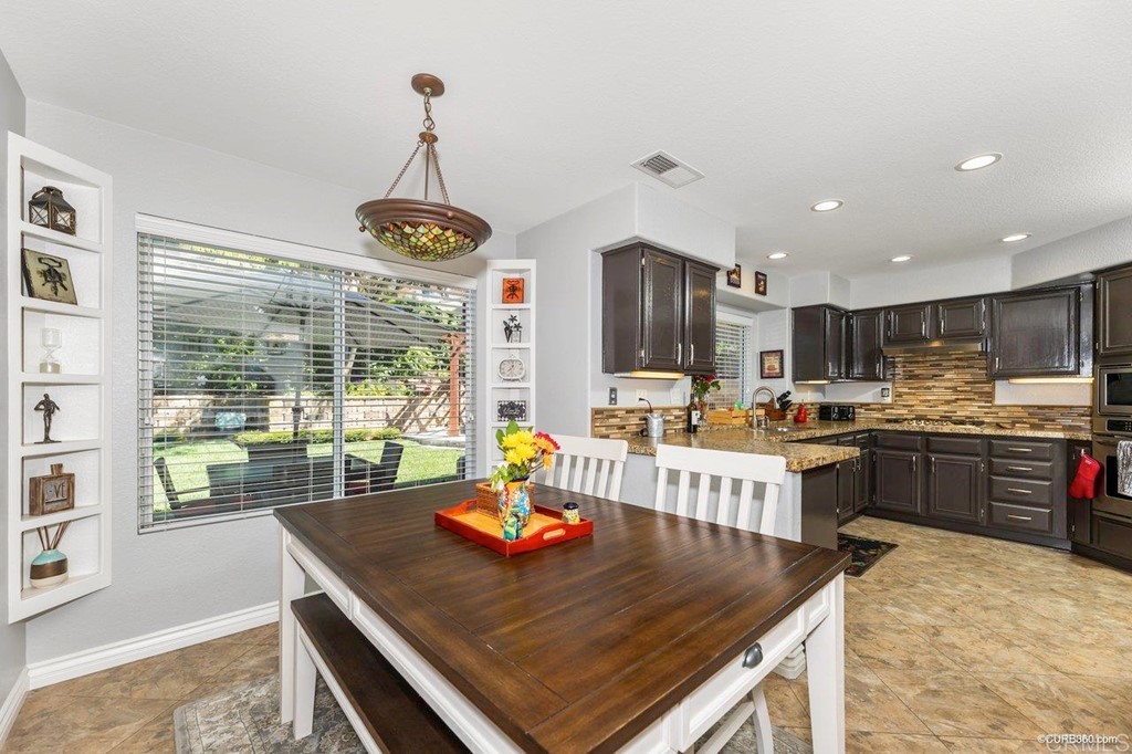 1840 Century Way Escondido, CA 92026 - Photo 13 of 36 a kitchen with kitchen island a large counter top space appliances and cabinets
